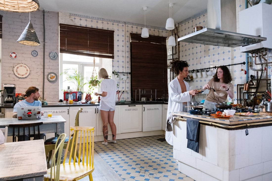 Adults spending time and cooking together in a shared kitchen